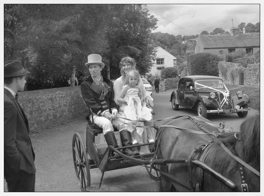 leaving the church in a horse-drawn carriage